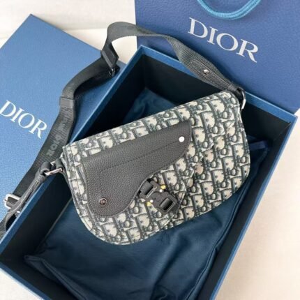 This Dior saddle bag is crafted in beige and black oblique printed fabrics Size: 24x16.5x5.5cm